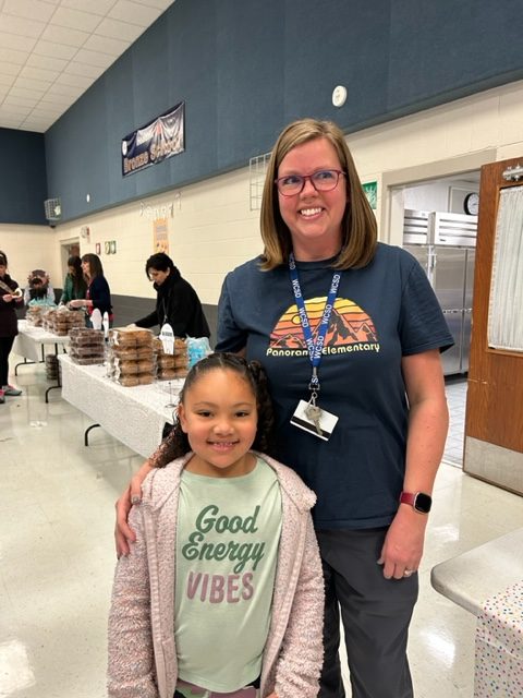 Mrs. Hensley posing with her student for Misses and Muffins