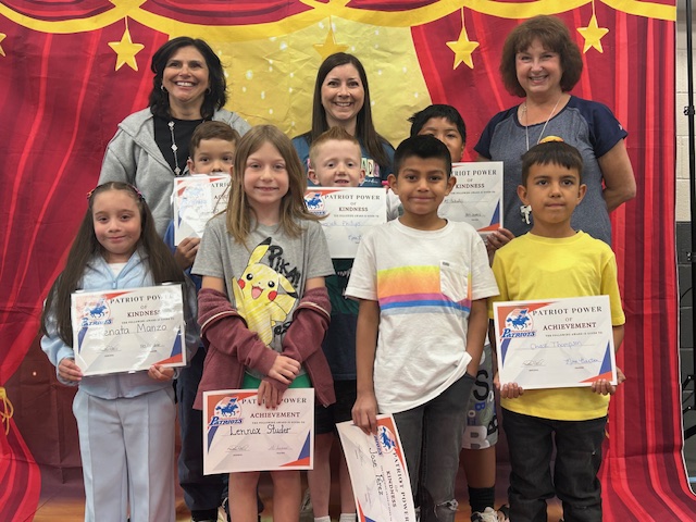 Teachers and students posing for the Patriot Power Awards for Kindness and Achievement.
