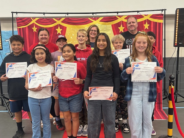 Fifth grade teachers and students posing for the Patriot Power awards for kindness and achievement.